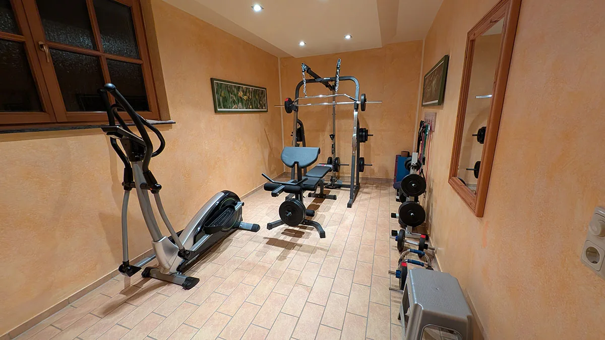 Fitnessraum mit Kraftgeräten und Fahrradtrainer im Landhaus Am Brockenblick
